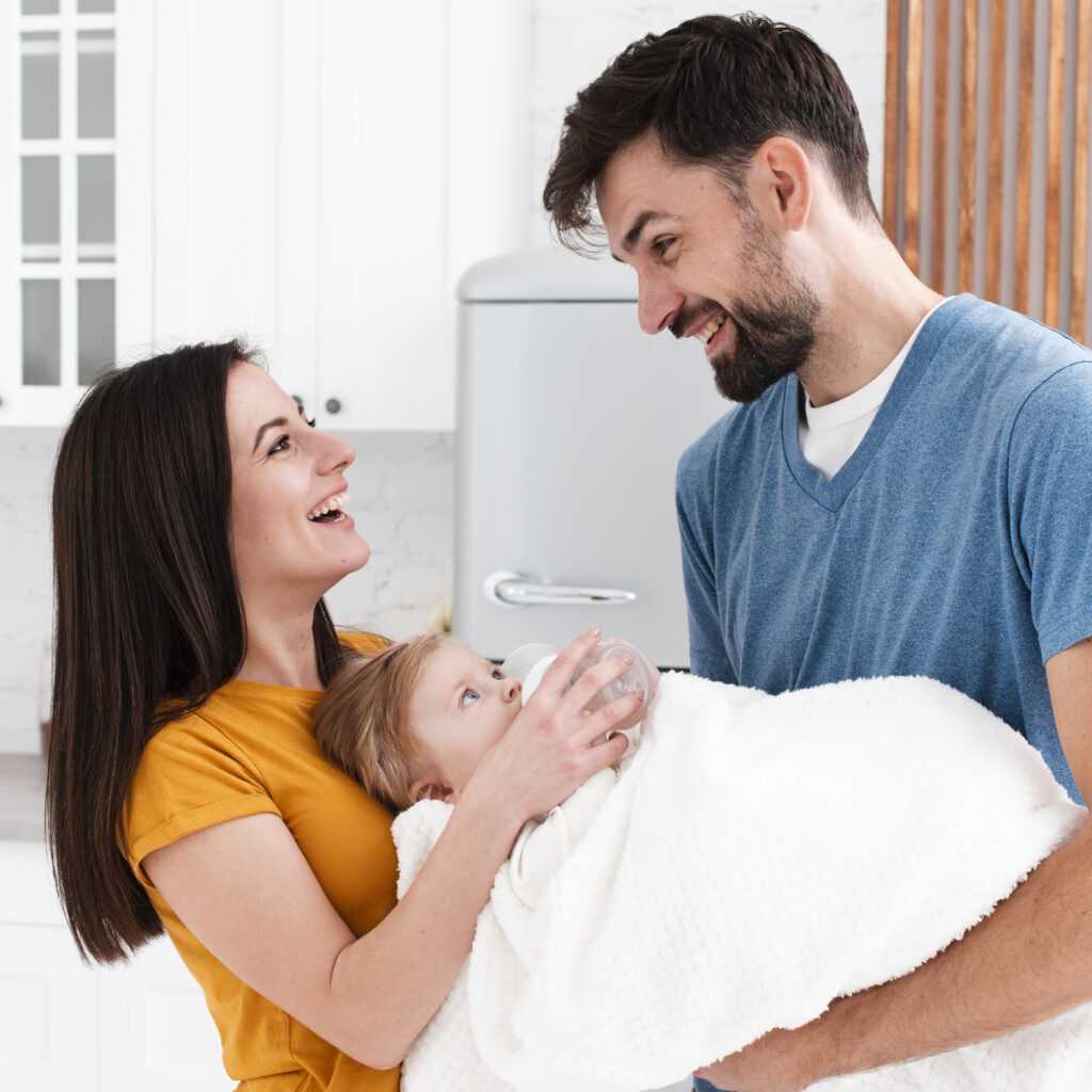 smiling-parents-holding-baby