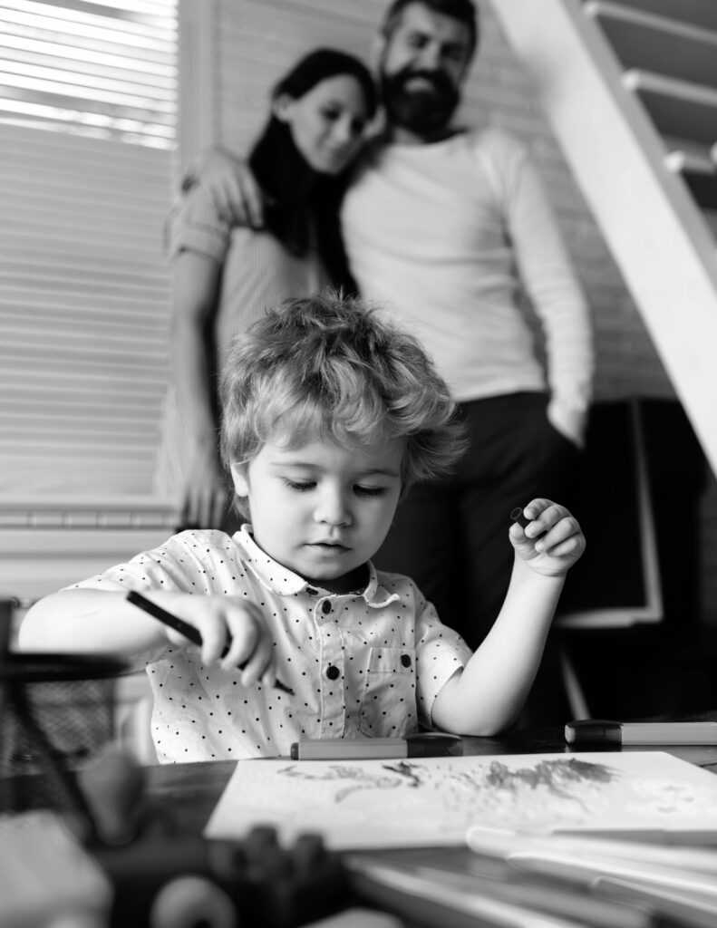 Young happy parents mom dad with child, family day parenthood childhood concept. Cheerful three people with cute child drawing enjoy weekends holidays. Kid learning painting, little artist drawing.